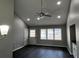 Living room with high ceilings, ceiling fan, and dark wood floors at 2755 Berry Rd, Loganville, GA 30052