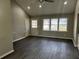 Living room with high ceilings, ceiling fan, and dark wood floors at 2755 Berry Rd, Loganville, GA 30052