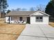House with white exterior, front porch, and driveway at 2605 Bobo Rd, Dallas, GA 30157
