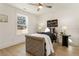 Charming bedroom with a gray upholstered bed and ceiling fan at 2605 Bobo Rd, Dallas, GA 30157
