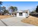 Newly built home with modern farmhouse exterior, welcoming front porch, and driveway at 2605 Bobo Rd, Dallas, GA 30157