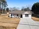 Newly built home with a modern farmhouse exterior, welcoming front porch, and large driveway at 2605 Bobo Rd, Dallas, GA 30157