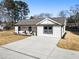 Charming one-story home with a white exterior and gray roof at 2605 Bobo Rd, Dallas, GA 30157