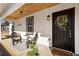 Front porch with wooden ceiling, black chairs, and a welcome mat at 2605 Bobo Rd, Dallas, GA 30157