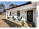 Inviting front porch with black framed door and white exterior at 2605 Bobo Rd, Dallas, GA 30157