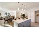 Modern kitchen with gray cabinets, island with seating, and open concept at 2605 Bobo Rd, Dallas, GA 30157