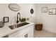 Laundry room with white cabinets and a stainless steel sink at 2605 Bobo Rd, Dallas, GA 30157