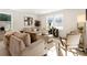 Relaxing living room with beige sofas, wood accent chair, and natural light at 2605 Bobo Rd, Dallas, GA 30157