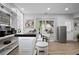 Home bar featuring seating, refrigerator, and backyard access at 456 Crestmont Ln, Canton, GA 30114