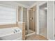 Bathroom featuring soaking tub with tile surround and glass shower, next to a walk in closet at 456 Crestmont Ln, Canton, GA 30114
