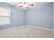 Bedroom featuring a ceiling fan, neutral paint, carpeted floor, and a window overlooking the yard at 456 Crestmont Ln, Canton, GA 30114