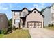 Beautifully landscaped two-story brick home with a two-car garage and inviting curb appeal at 456 Crestmont Ln, Canton, GA 30114