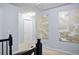 Hallway with neutral walls leads to different areas and has decorative art hanging on the walls at 456 Crestmont Ln, Canton, GA 30114