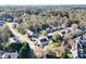 Wide aerial shot of a neighborhood, highlighting the home's location amidst lush greenery and trees at 3820 Mast Nw Ct, Kennesaw, GA 30144