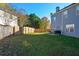 Large fenced backyard with a grassy lawn, a patio area, and mature trees at 3820 Mast Nw Ct, Kennesaw, GA 30144