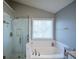 Updated bathroom with a glass shower and soaking tub at 3820 Mast Nw Ct, Kennesaw, GA 30144