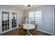 Charming breakfast nook with white table and four chairs, adjacent to French doors at 3820 Mast Nw Ct, Kennesaw, GA 30144