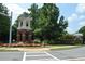 Community entrance features a brick tower, colorful flowers, and well-maintained landscaping at 3820 Mast Nw Ct, Kennesaw, GA 30144