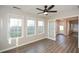 Charming sunroom with wood-look floors, a ceiling fan, and plenty of windows for natural light at 3820 Mast Nw Ct, Kennesaw, GA 30144