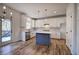 Open concept kitchen with white cabinets, island, hardwood floors, and French doors at 1005 Middlebrooke Dr, Canton, GA 30115