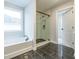 Bathroom with soaking tub, walk-in shower, and dark tile floors at 1700 Fulmont Cir, Mableton, GA 30126