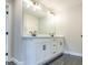 Double vanity with white cabinets and black hardware at 1700 Fulmont Cir, Mableton, GA 30126