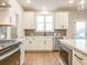 Modern kitchen with white cabinets, stainless steel appliances and gray tile backsplash at 1700 Fulmont Cir, Mableton, GA 30126