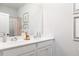 Clean bathroom featuring a double vanity with white countertops, dual sinks, and a large mirror at 128 Kingsley Way, Acworth, GA 30102