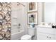 Clean bathroom with a tub, shower, and modern patterned shower curtain at 128 Kingsley Way, Acworth, GA 30102