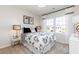 Bright bedroom with black and white floral bedding, accent pillows, bedside table and decorative lamps at 128 Kingsley Way, Acworth, GA 30102