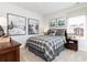 Comfortable bedroom featuring a plaid comforter, a decorative bear pillow, and mountain-themed artwork at 128 Kingsley Way, Acworth, GA 30102