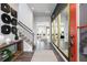 Bright foyer with dark wood floors, staircase, decorative mirrors, and a view into the open-concept living space at 128 Kingsley Way, Acworth, GA 30102