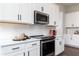 Close-up of modern kitchen featuring stainless steel appliances and white cabinets at 128 Kingsley Way, Acworth, GA 30102