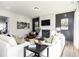 Cozy living room featuring a fireplace, modern decor, comfortable seating, and a large window with natural light at 128 Kingsley Way, Acworth, GA 30102