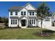 Two-story white farmhouse with black accents and landscaping at 3810 Reserve Overlook Lot14 Way, Cumming, GA 30041