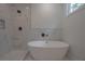 Modern bathroom featuring a soaking tub, a shower with elegant marble tiling, and sleek fixtures at 3007 Holly St, Canton, GA 30115