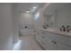 Modern bathroom featuring double sinks, soaking tub, and beautiful marble tile flooring at 3007 Holly St, Canton, GA 30115