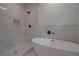 Modern bathroom featuring a soaking tub, a shower with elegant marble tiling, and sleek fixtures at 3007 Holly St, Canton, GA 30115