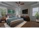 Staged bedroom with large windows providing natural light, wood flooring and modern ceiling fan at 3007 Holly St, Canton, GA 30115