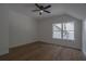 A secondary bedroom with beautiful wood flooring and a bright window at 3007 Holly St, Canton, GA 30115