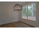 Bright dining area features a contemporary light fixture and large windows with a wooded view at 3007 Holly St, Canton, GA 30115