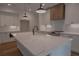 Kitchen island with white marble countertop, farmhouse sink, and stainless steel dishwasher at 3007 Holly St, Canton, GA 30115