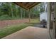 A covered patio overlooks a spacious yard and wooded area, creating a private outdoor space at 3007 Holly St, Canton, GA 30115