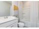 Bright bathroom with white tub, shower, matching vanity, and framed mirror above the sink at 353 Skylar Se Way, Atlanta, GA 30315