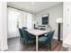 Bright dining room featuring stylish teal chairs, wood floors, and natural light at 353 Skylar Se Way, Atlanta, GA 30315