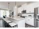 Well-lit kitchen featuring a large center island with seating, stainless steel appliances and white cabinetry at 353 Skylar Se Way, Atlanta, GA 30315