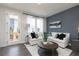 Bright living room featuring neutral tones, stylish decor, and a sliding glass door to the deck at 353 Skylar Se Way, Atlanta, GA 30315