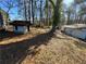 Large backyard with shed and mature trees at 6828 Delta Dr, Riverdale, GA 30274