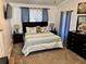 Large bedroom with a king-size bed and dark wood furniture at 6828 Delta Dr, Riverdale, GA 30274