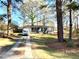 Ranch house with driveway and mature trees at 6828 Delta Dr, Riverdale, GA 30274